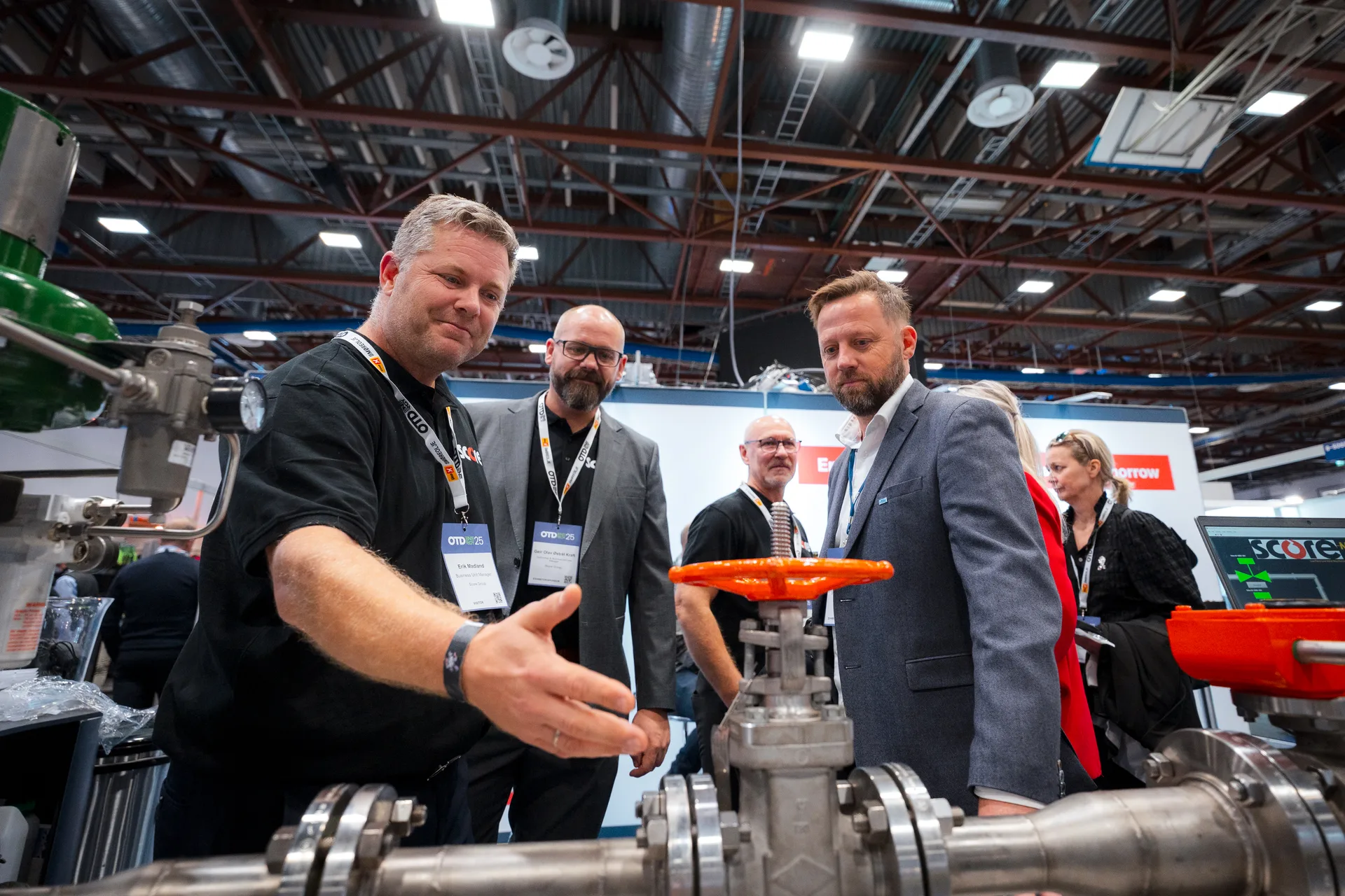 Operators discussing equipment at an exhibitor stand at OTD Energy 2025